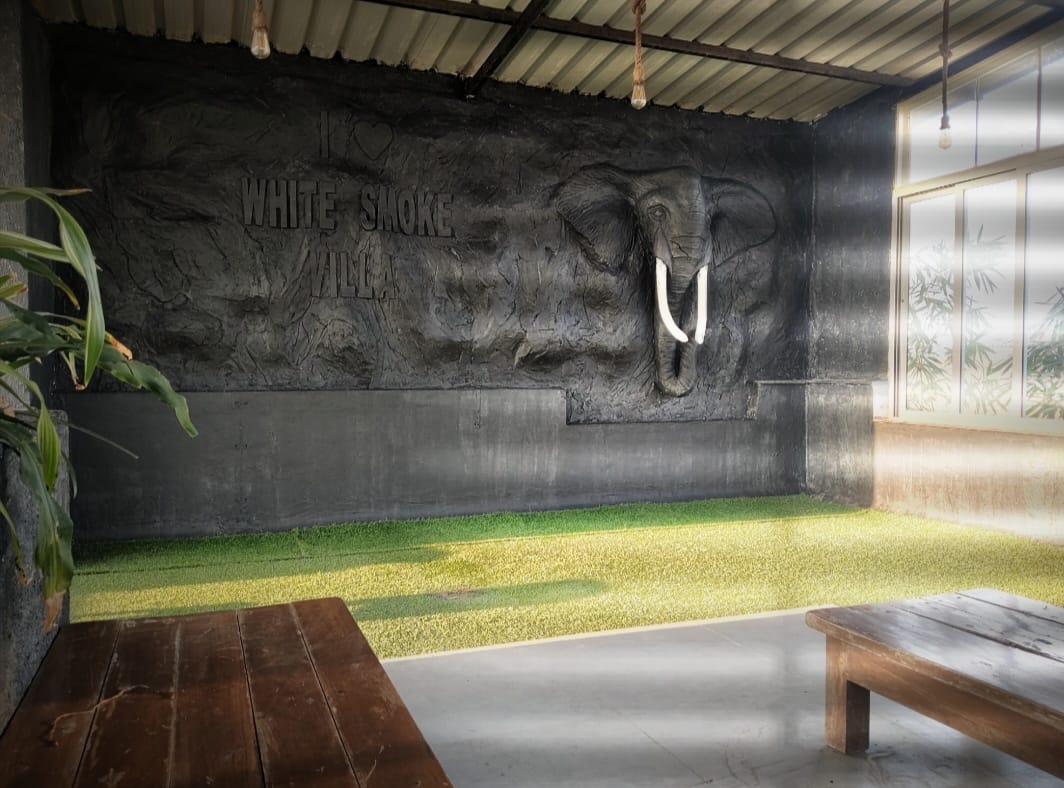 Rooftop lounge with the White Smoke Villa signature elephant wall